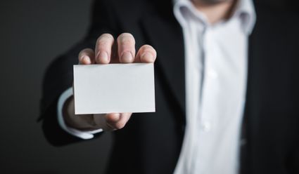 Person showing business card.