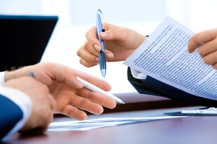 People going over and signing a contract
