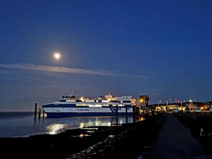 De veerboot bij vertrek in het donker 's ochtends vroeg