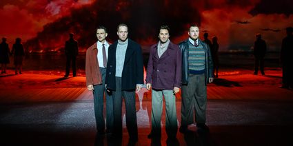 Four man standing on a stage