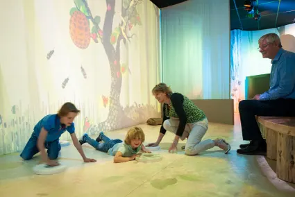Kinderen spelen samen met hun opa en oma in het museum