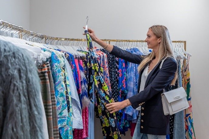 Designer Outlet Roosendaal, vrouw bekijkt kledingstuk