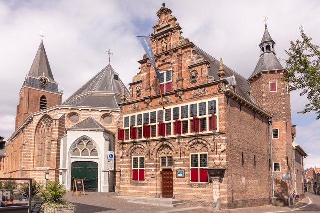 Het Stadsmuseum Woerden met zijn karakteristieke gevel en rode luiken, gelegen naast de Petruskerk in het historische centrum.