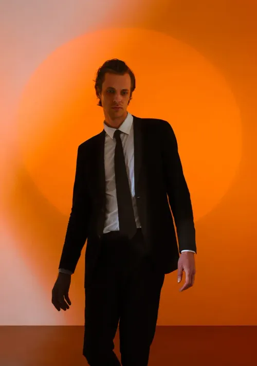 A picture of a man with an orange background