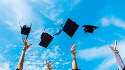 Graduation hats being thrown in the air
