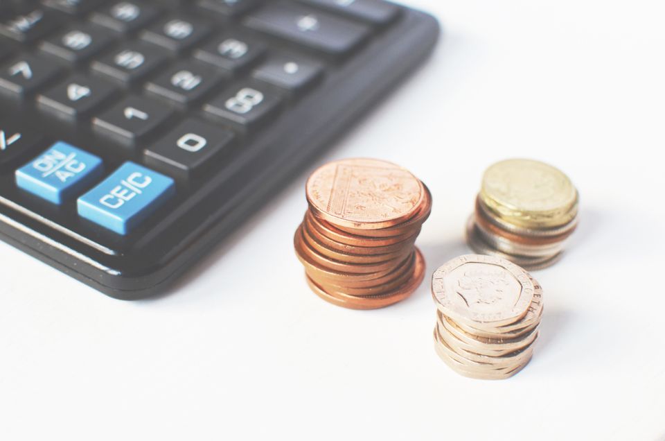Change and a calculator on a desk